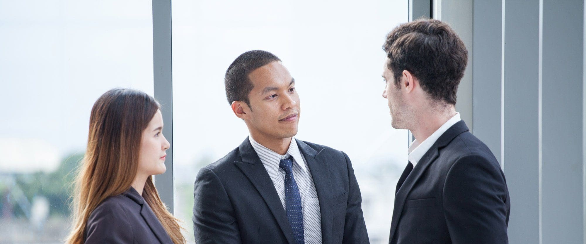 2 business men and a female translator meeting