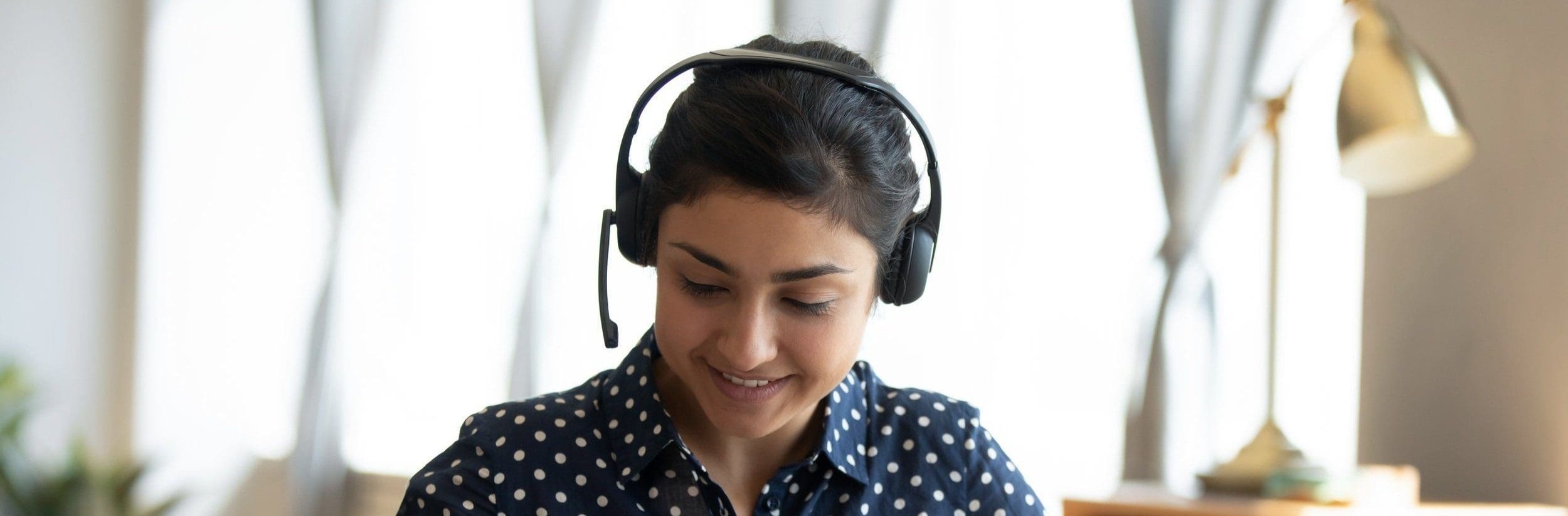 A female translator wearing a black headset