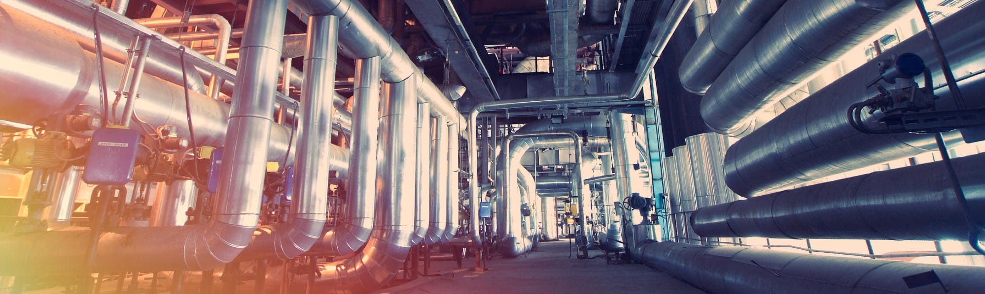 a picture of shiny steel pipework in a factory